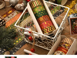 Detail of Christmas washi tape set with snowflakes and reindeer in a white metal basket