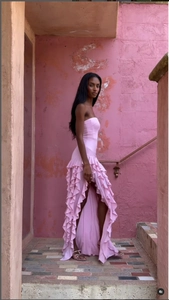 Détail d'une robe rose bustier élégante avec volants superposés et fente latérale