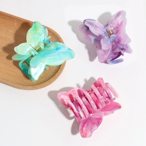Elegant butterfly hair claws with gradient marble patterns in blue, purple and pink