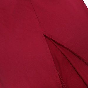 Detailed close-up of the side slit and fine stitching on the deep red bodycon dress