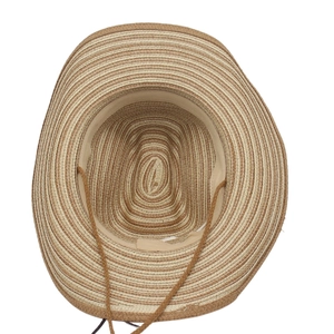 Detail of woven straw hat featuring textured brown stripes and adjustable windproof rope
