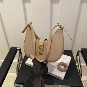 Khaki leather crescent moon shoulder bag with golden buckle and matching leather belt