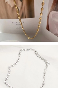 Detail of adjustable coffee bean links necklaces in gold and silver finish with lobster clasp