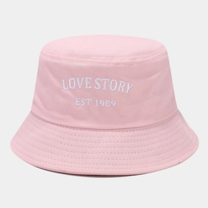 Detail of LOVE STORY letter embroidery on a pink cotton bucket hat for women