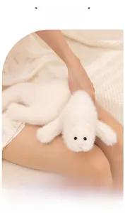 Close-up of soft white ferret plush toy showing fluffy texture and cute facial features