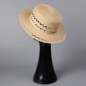 Detailed close-up of hollow diamond weave patterns on a natural straw boater hat