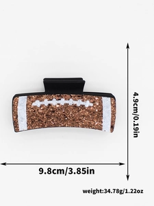 Brown glitter football hair clip with white stripe detail and 3.85in size dimensions