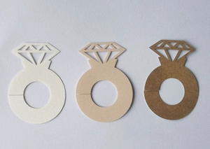 Detailed view of hollow diamond ring shaped place cards in three earthy gradient colors
