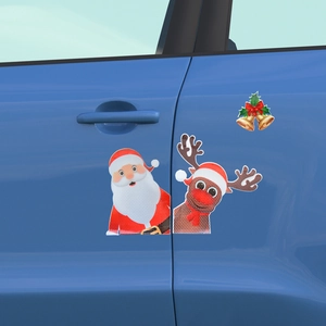 Detail of reflective Christmas magnets with Santa and reindeer on a blue car door