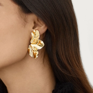 Minimalist golden leaf earrings with artistic wrinkled metal texture for women