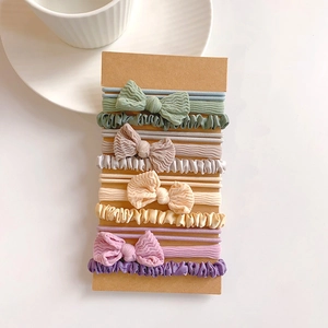 Detailed close-up of elastic hair scrunchies set with bow and textured fabric detail