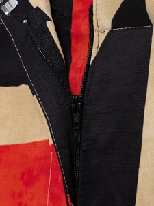 Detail of high-quality black zipper closure and textured color block fabric stitching