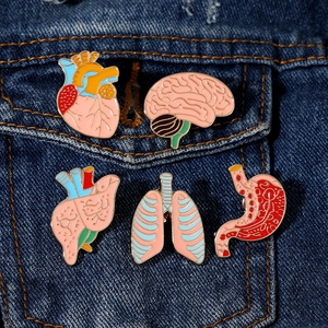 5-piece creative human organ enamel pins set on denim jacket featuring brain and heart models