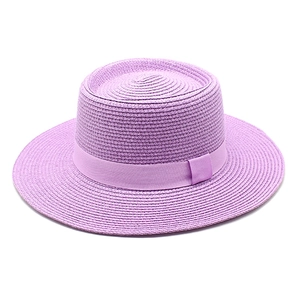 Detailed view of purple boater hat with fine weave texture and matching ribbon bow