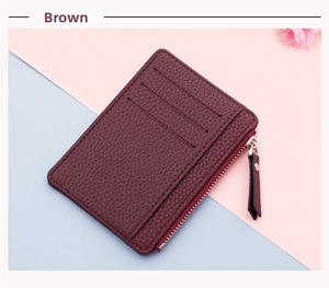 Detailed view of brown lychee grain leather card holder with three card slots and a zipper pocket