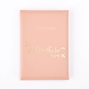 Close-up of pink PU leather passport holder with gold Adventure Begins lettering