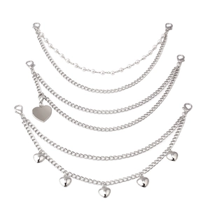 Silver multi-layer metal bag chain set with faux pearls and heart charms on white background