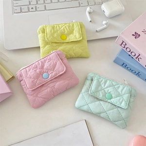 Detailed close-up of quilted candy-colored coin purses in yellow, pink and green fabric