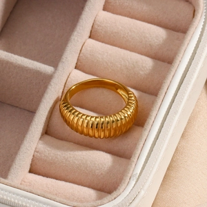 Detail view of 18K gold plated stainless steel ring with elegant striped texture