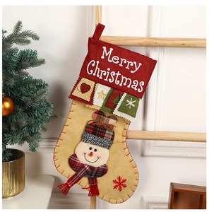 Close-up of burlap Christmas stocking with 3D snowman and Merry Christmas embroidery