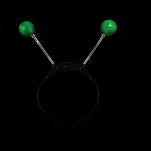 Detail of glowing alien eyeball headband with green glitter balls on silver springs