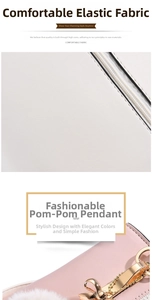 Detailed view of fashionable textured fabric with stylish pompon pendant and golden zipper