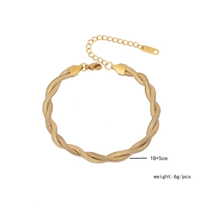 Detail view of golden double-strand braided bracelet with lobster clasp and extension chain