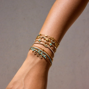 Chic gold-tone layered star and moon charm bracelet set with turquoise beads