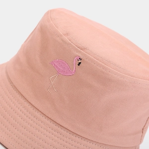 Close-up of flamingo embroidery on a pink canvas bucket hat showing fine stitching details