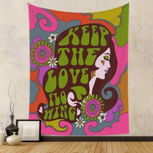 Psychedelic floral tapestry with Keep The Love Flowing text on a modern grey wall