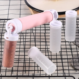 Manual cake airbrush pump for baking with four clear graduated tubes on a cooling rack