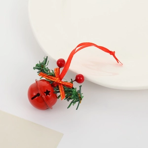 Detailed view of a red Christmas bell with star cutouts, red berries, and pine needles