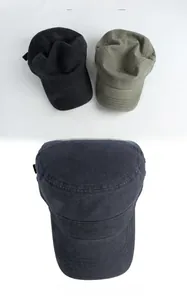 Detail view of washed cotton cadet caps showing stitching and vintage texture in black