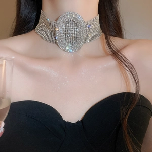 Macro detail of luxury silver choker featuring multi-row rhinestones and oval centerpiece