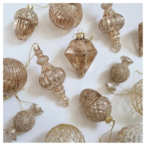 Detailed collection of champagne gold glass ornaments with glitter and pinecone textures