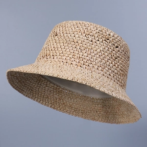 Detailed close-up of handmade raffia straw hat with inner sweatband for summer sun protection