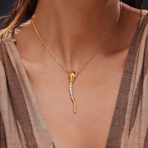 18k gold plated stainless steel snake pendant necklace with white zircons on a model