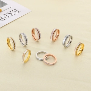 Close-up of stylish chain rings with pavé rhinestones in gold, silver, and rose gold finishes