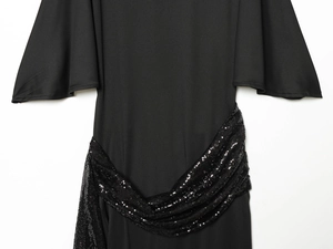 Detail view of the black midi dress featuring a sequined waist belt and flared sleeves