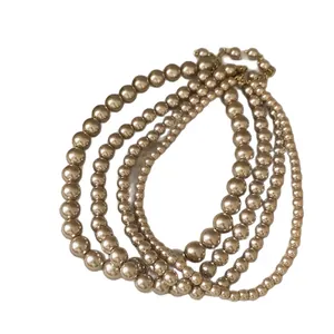 Collier de perles dorées champagne vintage à plusieurs rangs au design élégant