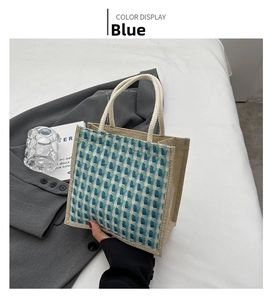 Detail of blue tweed tote bag with natural linen sides and white cotton rope handles