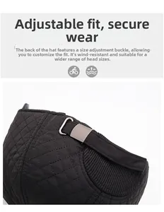 Detail of black quilted baseball cap featuring an adjustable silver metal buckle at the back