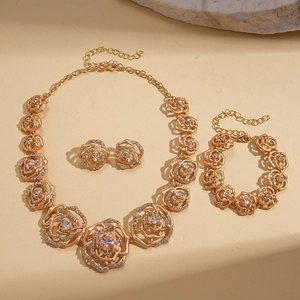 Elegant gold-tone rose jewelry set with sparkling rhinestones including necklace and earrings