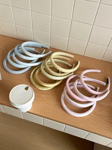 Detail showing assorted pastel yellow and blue satin headbands with polka dots and checks