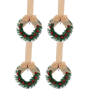 Set of 4 mini Christmas wreaths with red berries and burlap bows on white background