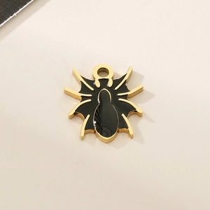 Macro detail of golden spider pendant with black enamel finish for Halloween DIY jewelry