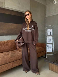 Women's vintage coffee half-zip sweatshirt and wide-leg sweatpants set in a casual indoor setting