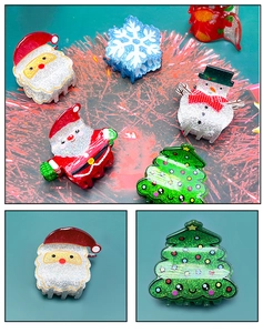 Macro detail of glittery Christmas tree and snowman hair claws with festive sparkles