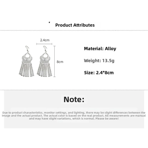 Detailed size view of silver vintage tassel earrings with hollow patterns, 2.4cm by 8cm