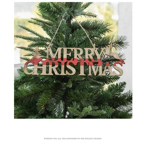 Close-up of wooden Merry Christmas tree ornament with red ribbon and hollow lettering